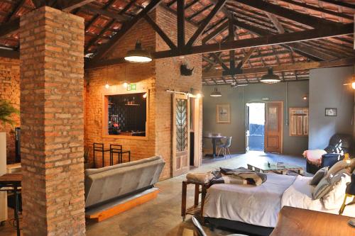 a room with two beds and a brick wall at Loft Industrial in Santo André