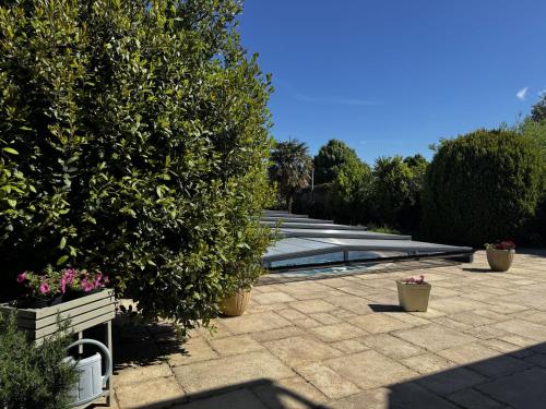 a patio with plants and a pool in a yard at Holiday Home La houle by Interhome in Cancale