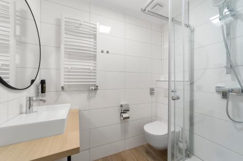 a white bathroom with a toilet and a sink at NEU - Sona Design Rooms - CITY CENTER - in Bamberg