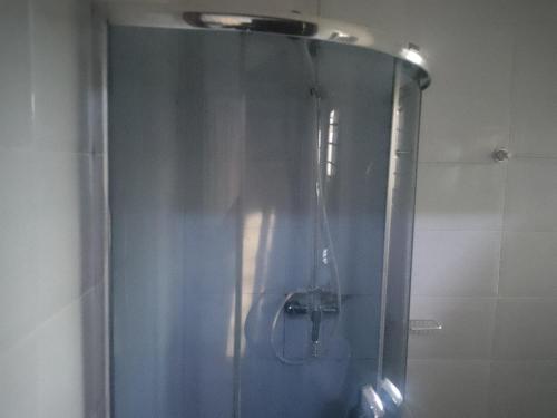 a shower with a glass door in a bathroom at Edo Global Boutique apartment in Benin City