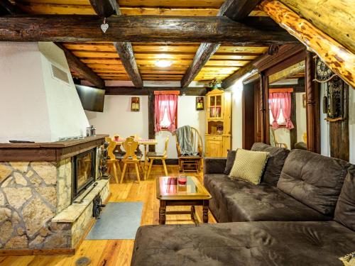 a living room with a couch and a fireplace at Chalet Pine Hill by Interhome in Klenovnik