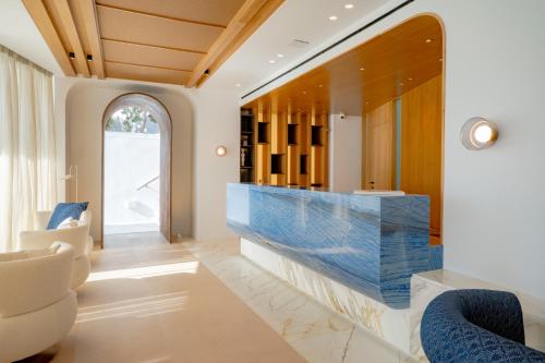 a living room with a large blue stone fireplace at Apeiron Blue Santorini by Apeiron Hotels in Fira