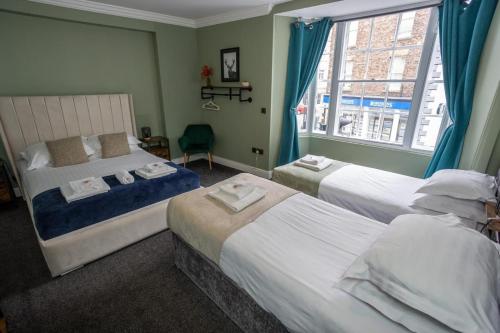 a bedroom with two beds and a window at The City in Durham