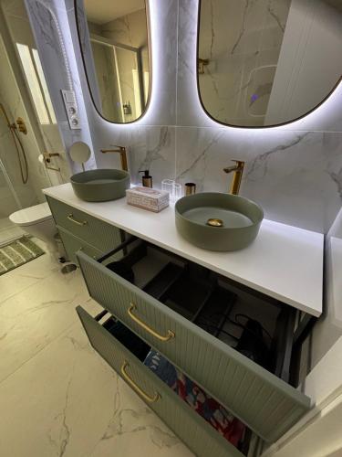 a bathroom with two sinks and a mirror at Mi Capricho in Mijas Costa