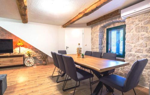 a dining room with a wooden table and chairs at Stone house Lila Kamenmost Imotski in Kamenmost