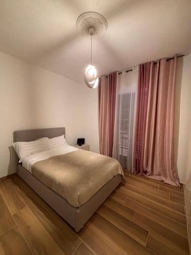a bedroom with a bed and a large window at De Chri House in Cisterna di Latina