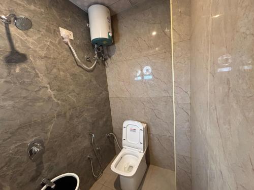 a bathroom with a toilet and a shower at Hotel Shree Radhe Mohan And Resort in Khātu