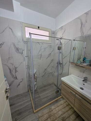 a bathroom with a shower and a sink at PERLA Vision Resort in Draç