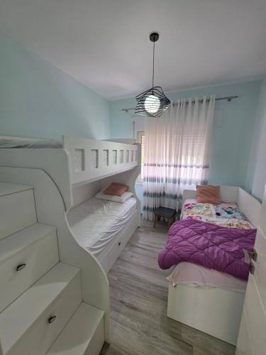 a bedroom with two bunk beds and a bed at PERLA Vision Resort in Draç
