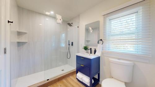a bathroom with a shower and a toilet and a sink at Coastal Estate in Cape May