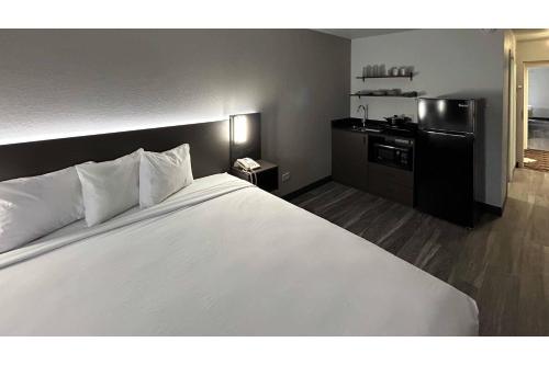 a large white bed in a hotel room at Studio 6 Pocatello, ID in Pocatello