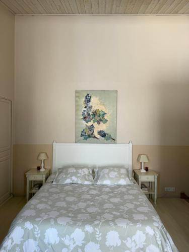 a bedroom with a bed and two nightstanduments at La Maison de Marie in Blaye