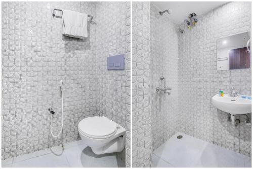 a bathroom with a shower and a toilet and a sink at FabHotel Backstreet, Bhopal Railway Station in Bhopal