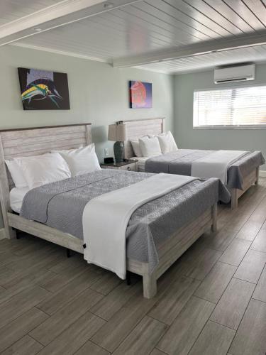 two beds sitting in a room with at The Conch House Marina Resort in St. Augustine