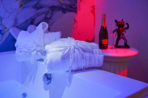 a bathroom with a towel and a bottle of wine at DRM Bed&Breakfast in Marcianise