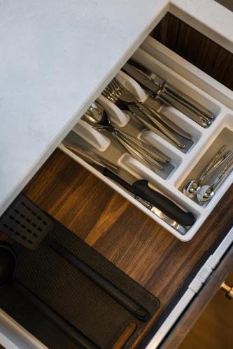 a drawer filled with knives and utensils in a kitchen at ММ GROUP APARTMENT in Uzhhorod