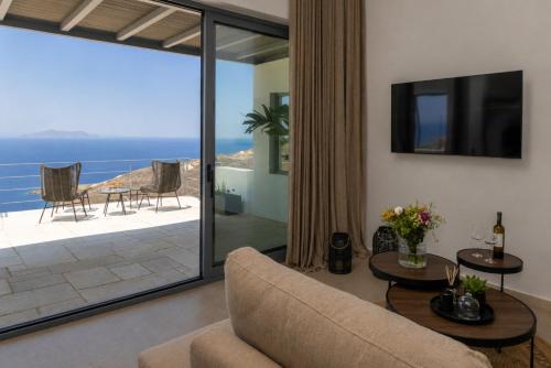 a living room with a view of the ocean at Tinian Sunset Suite in Istérnia