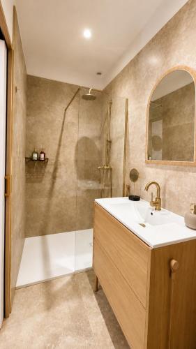 a bathroom with a sink and a shower at Casa Luna in Saint-Chamond