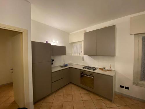an empty kitchen with white cabinets and a sink at Il Nido in Costa Masnaga