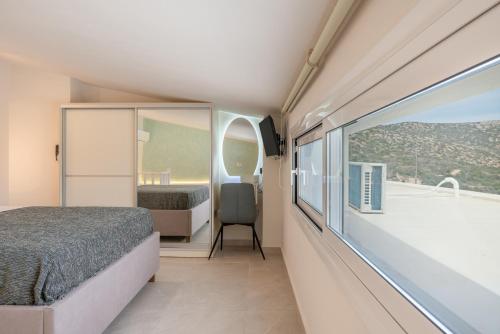 a small bedroom with a bed and a balcony at Aqua Blue Villa in Amoopi