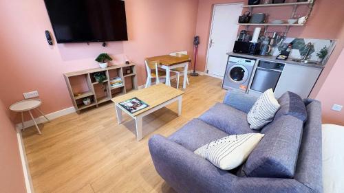 a living room with a couch and a table at Studio Flat in Seymour Road in Bristol