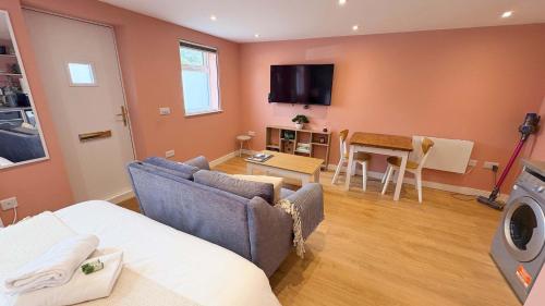 a living room with a couch and a table at Studio Flat in Seymour Road in Bristol