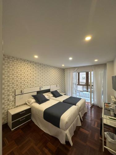 a bedroom with a large bed in a room at Hostal San Fernando in Santander
