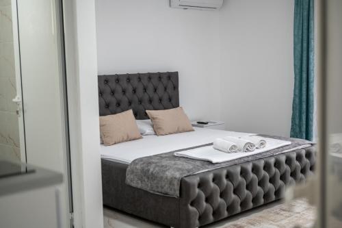 a bedroom with a large bed and a mirror at Allma Kitesurf in Donji Štoj