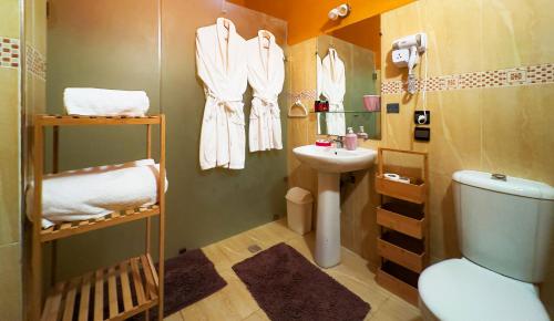 a small bathroom with a toilet and a sink at Domaine Couleurs Berbères, Piscine, Vue Atlas, Bivouac & Expériences à Lalla Takerkoust in Lalla Takerkoust
