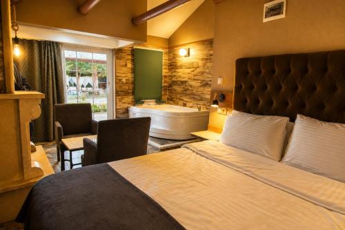 a bedroom with a large bed and a bath tub at 216 North Hotel in Ağva