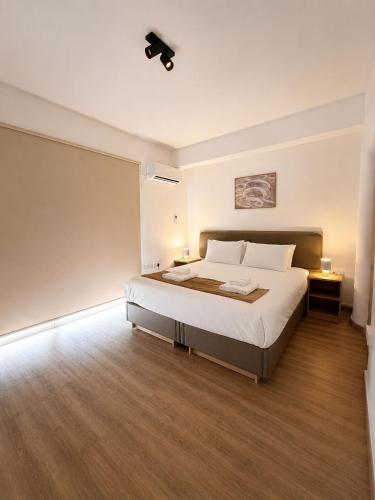 a bedroom with a large bed in a room at Valentino By ERMASS ex Valentinos Apts in Paphos