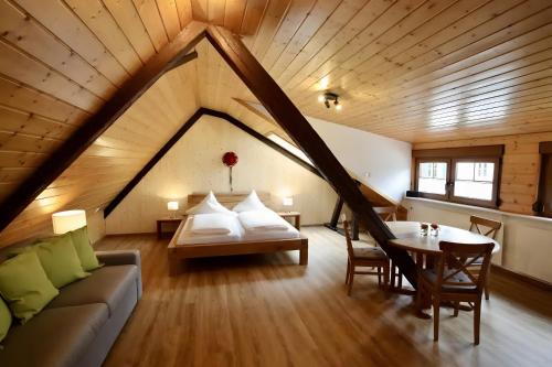 a room with a couch and a table in a attic at Roserhof Gengenbach in Gengenbach