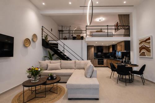 a living room with a couch and a table at Tinian Sunset Suite in Istérnia