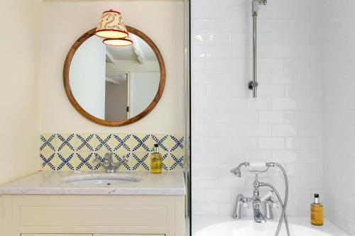 a bathroom with a sink and a mirror at Fernhalls Mill in Munslow