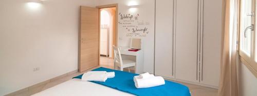 a room with a bed and a desk in it at Mediterranean Sea Shell Pool House in Budoni