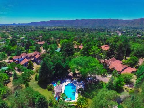 an aerial view of a home with a swimming pool and trees at Blumenau Apart Hotel in Villa General Belgrano