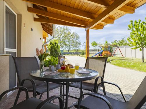 a patio with a table and chairs and a playground at Apartment Lena 2 by Interhome in Balatonberény