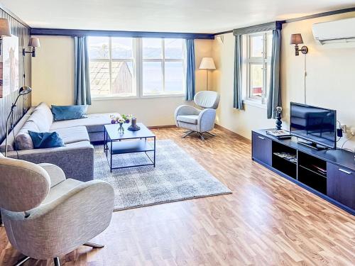 a living room with a couch and a tv at Apartment Floren by Interhome in Herand