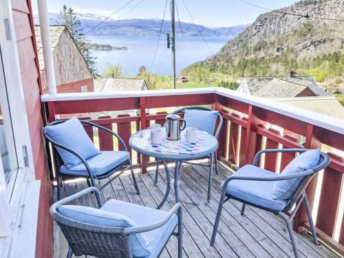 a table and chairs on a balcony with a view at Apartment Floren by Interhome in Herand