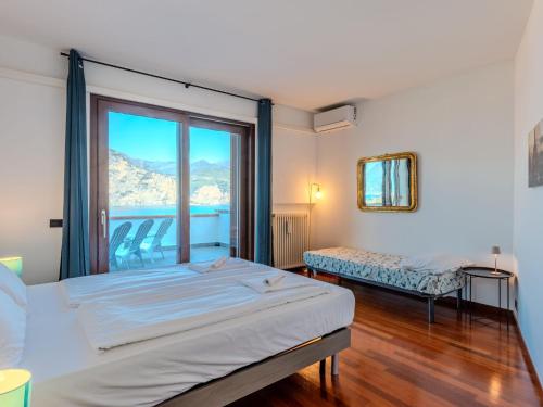 a bedroom with a bed and a large window at Villa Manuela by Interhome in Brenzone sul Garda