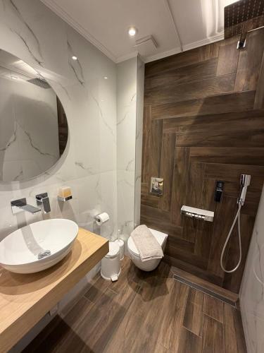 a bathroom with a sink and a toilet at MG Luxury Living in Nea Vrasna