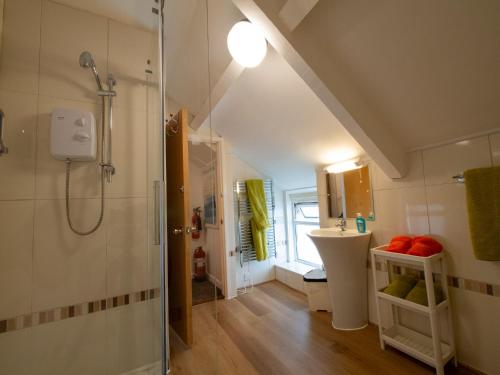 a bathroom with a shower and a sink at Culver House Hotel in Port-Eynon