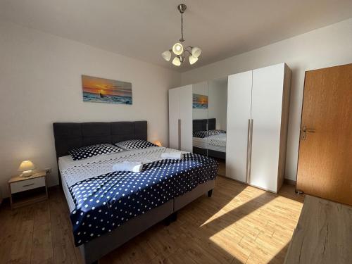 a bedroom with a bed and a mirror in it at Apartman Helena in Senj