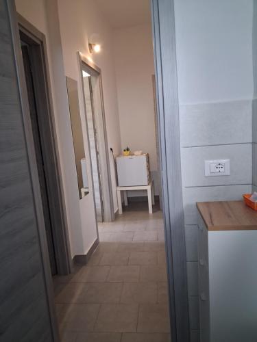 a hallway leading to a bathroom with a sink in a room at Amoenus Bed & Breakfast in family in Soverato Marina