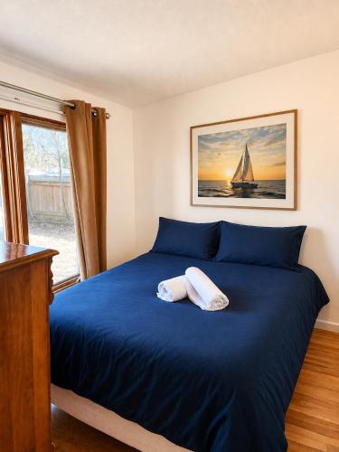 a bedroom with a blue bed with a sailboat on it at 58 River Rd. East in Wasaga Beach