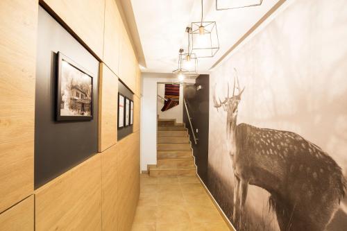 a hallway with a painting of a deer on the wall at Complex Vazrozhdentsi in Tryavna