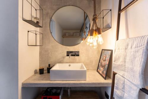 a bathroom with a sink and a mirror at Open Space Mi Alma Lake View in Toscolano Maderno