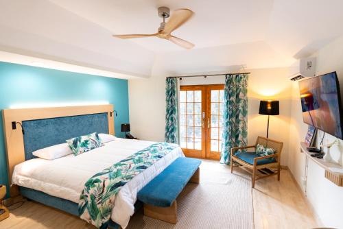 a bedroom with a bed and a ceiling fan at Fourways Inn in Chelston