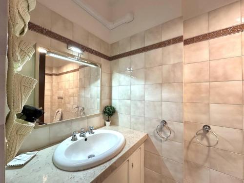 a bathroom with a sink and a mirror at La terrazza su Assisi in Assisi