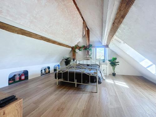 a large room with a bed in a attic at Charming studio Terrace and parking in Le Mans